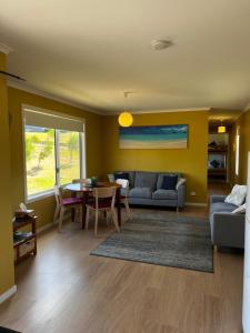 a living room with a couch and a table at Bruny Seaview Escape in Alonnah
