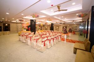a row of chairs in a banquet hall at Hotel Vijay Palace in Agra