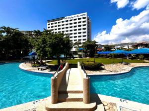 a resort with a slide in the middle of a pool at EGI Cebu Resort and Hotel in Maribago
