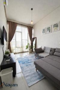 a living room with a couch and a table at Alayam Villa Padalarang near whoosh, wahoo waterworld & ikea in Padalarang