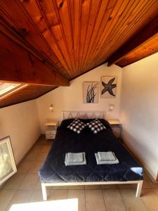 a bedroom with a bed with a wooden ceiling at Terrazza Belvedere Sanremo in Sanremo