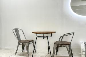 two chairs and a table and a table and two chairs at S Hotel in Bucheon