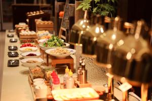 a buffet line with bowls of food and wine bottles at Zhong An Hotel Beijing Former Residence of Journalist Edgar Snow in Beijing