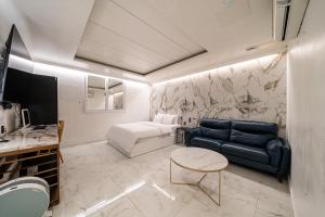a living room with a couch and a table at S Hotel in Bucheon