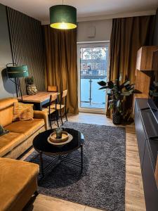 a living room with a couch and a table at Apartamenty TBG Tarnobrzeg in Tarnobrzeg