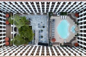 an aerial view of a building with a swimming pool at DoubleTree by Hilton Austin in Austin