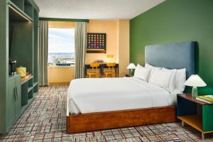 a bedroom with a large bed and a balcony at the Curtis Denver - A DoubleTree by Hilton Hotel in Denver +86 photos