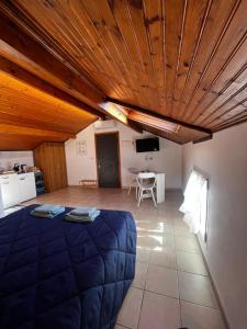 a room with a bed and a table in it at Terrazza Belvedere Sanremo in Sanremo