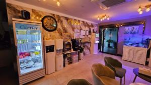 a restaurant with a refrigerator and a clock on the wall at Cherryblossom in Changwon
