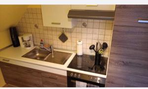 a kitchen with a sink and a counter top at Haus Seemöwe Obergeschoss in Wittmund