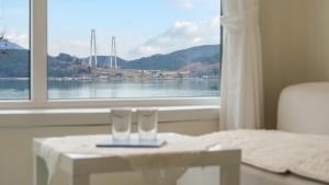 two glasses on a table in front of a window at Yeosu Jangsuri Poolvilla&Spa Pension in Yeosu +3 photos