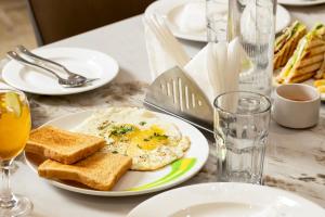 a table with a plate of eggs and toast at The Orion Premium Suites in Mumbai
