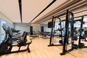 a gym with treadmills and elliptical machines at Novotel Pune Viman Nagar Road in Pune