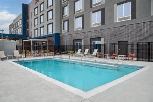 a swimming pool in front of a building at Hampton Inn Midland West in Midland