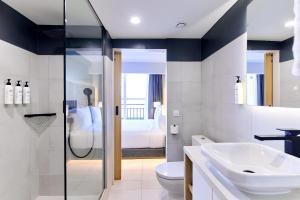 a bathroom with a sink and a toilet at Radisson Hotel Paramaribo in Paramaribo