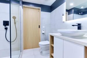 a bathroom with a toilet and a sink and a shower at Radisson Hotel Paramaribo in Paramaribo