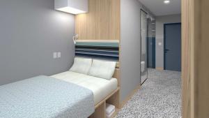 a small bedroom with a bed and a walk in closet at Radisson Hotel Paramaribo in Paramaribo +62 photos