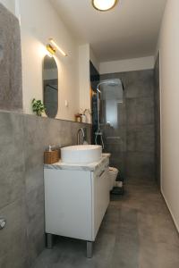 a bathroom with a sink and a toilet at Wonder Bűbáj Mátrafüred in Gyöngyös