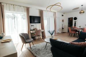 a living room with a couch and chairs and a table at Wonder Bűbáj Mátrafüred in Gyöngyös