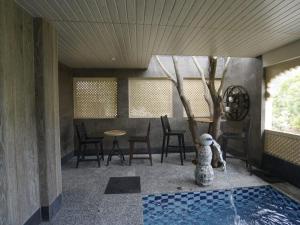 a room with a pool with a table and chairs at aurum villa's kodiyat in Nāi