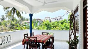 a table and chairs on a balcony with a view at Oliviana Resort in Bentota