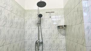 a shower with a shower head in a bathroom at Oliviana Resort in Bentota +26 photos