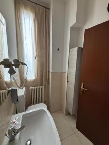 a bathroom with a sink and a toilet and a window at GioIre Home Wellness in Como