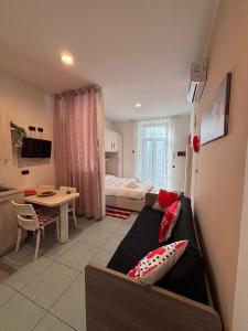 a living room with a couch and a bedroom at GioIre Home Wellness in Como