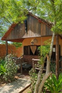 a house with a bench in front of it at Auberg'inn in Toliara