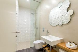 a white bathroom with a sink and a shower at LETHESHOME Apartments in Porto +23 photos