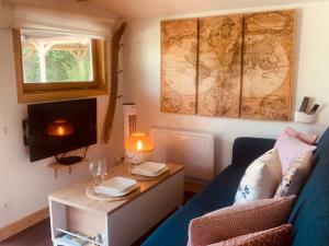 a living room with a blue couch and a table at Chalet La Romance in Prouilly