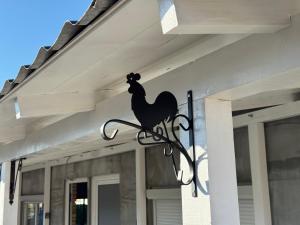 a chicken sign on the side of a house at Apartmani Petra Bezdan in Bezdan +35 photos