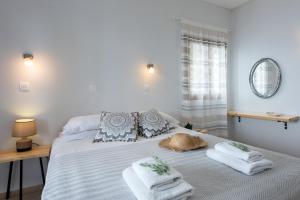 a bedroom with a bed with towels on it at Hotel Barbati - Seaside Getaways with Pool in Barbati +33 photos