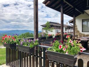 a fence with pots of flowers on it at Balkana Village in Kalaydzhii +49 photos