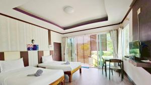 a hotel room with two beds and a window at Lake Terrace Resort in Langu