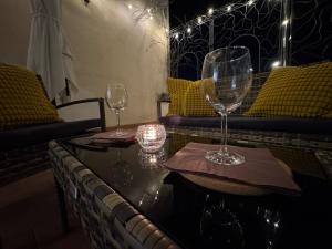 two wine glasses sitting on top of a table at Bencivenga Terrace in Rome