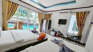 a bedroom with two beds and a large window at Lake Terrace Resort in Langu +90 photos