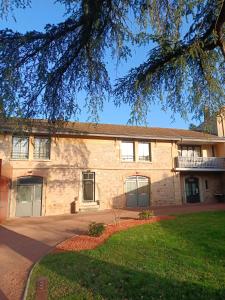 a large brick building with a yard in front of it at Appart'Hotel Parc Johan in Chauffailles