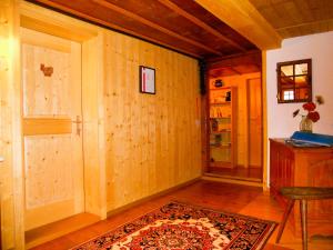 a room with wooden walls and a door and a rug at BnB Haus Itten in Hondrich +19 photos