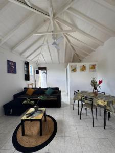 a living room with a couch and a table at Ti Kaz in Petit-Bourg