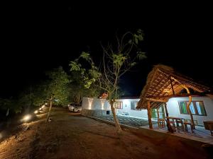 a night time view of a house with a tree at Wilpattu Leisure Villa in Pahala Maragahawewa