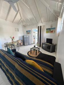 a living room with a couch and a table at Ti Kaz in Petit-Bourg