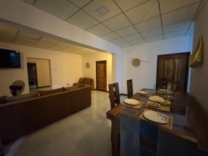 a living room with a table and a couch at Wilpattu Leisure Villa in Pahala Maragahawewa