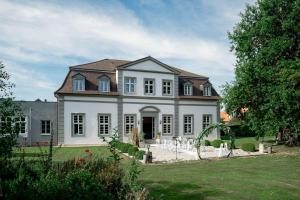 a large white house with a lot of windows at Jagdschloss Friedrichsthal in Waldeck