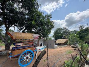 a horse drawn carriage in front of a building at Wilpattu Leisure Villa in Pahala Maragahawewa +6 photos
