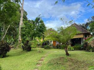 a house in the middle of a yard at Abian view house in Sidemen