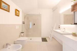a white bathroom with two sinks and a toilet at "Venetian Elegance Villa" - near Venice historic center in Mira +45 photos