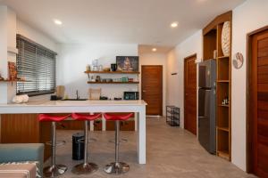 a kitchen with a counter and stools in a room at v26 Sunset Dreams - Seaview in Haad Yao in Haad Yao