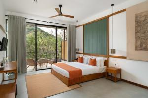 a bedroom with a bed and a balcony at Te Dalu Resort & Spa - A Luxury Sanctuary in Ella in Ella