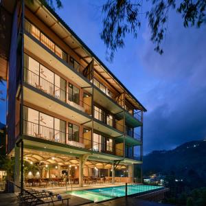a building with a swimming pool in front of it at Te Dalu Resort & Spa - A Luxury Sanctuary in Ella in Ella